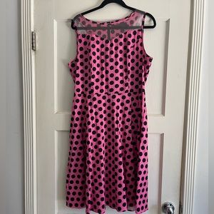 Sleeveless pink dress with black polka dots